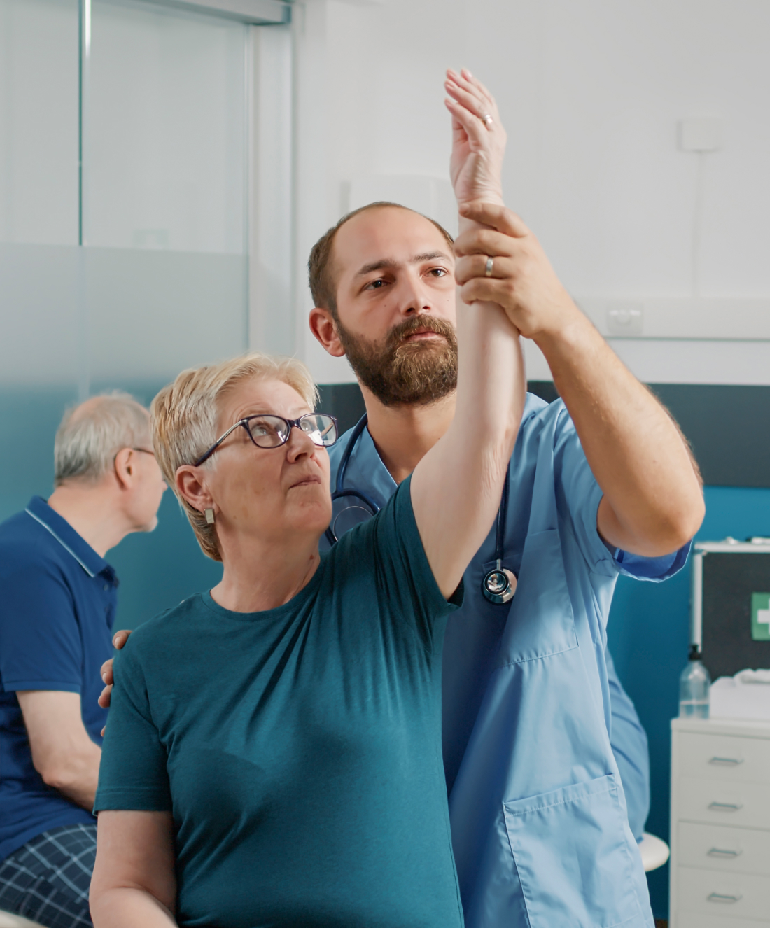 orhopedic specialist doing arms stretch exercise with elder patient